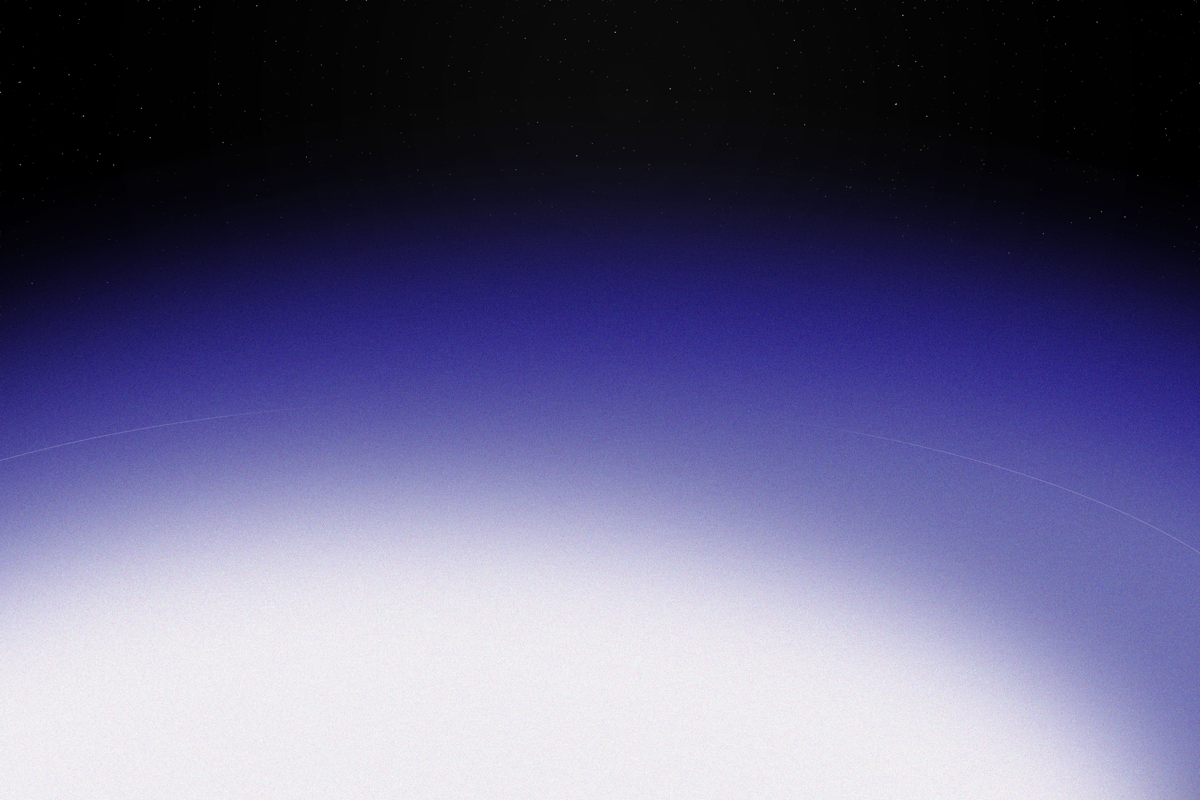 Earth's curved horizon beneath a star field